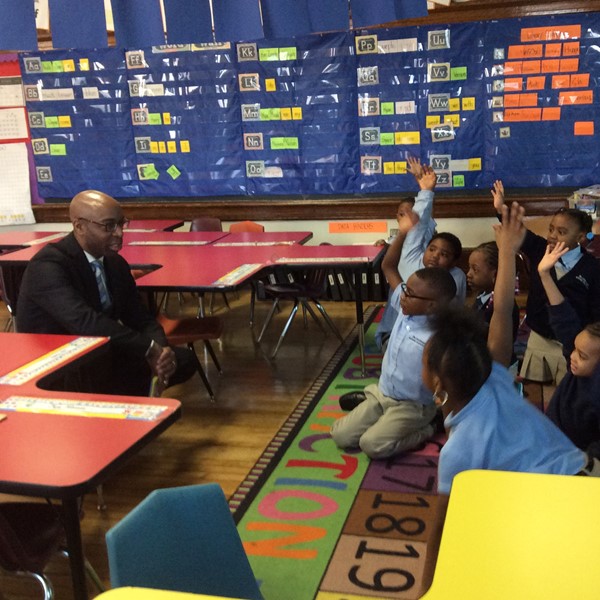 Mr. Garlin, CEO of DLEACS prepares to read to kindergarten students.